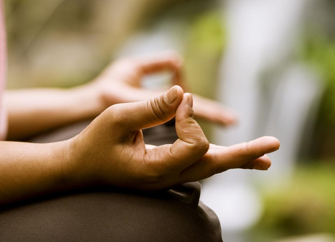 Fingers meditating in peaceful surroundings